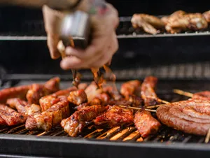 a person is cooking meat on a grill jigsaw puzzle