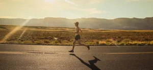 man in black shorts running on gray asphalt road during daytime jigsaw puzzle
