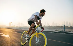 man riding bicycle on road during daytime jigsaw puzzle
