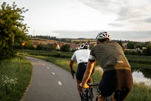 man in brown t-shirt riding on bicycle on road during daytime jigsaw puzzle