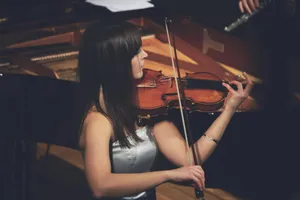 woman playing violin beside grand piano jigsaw puzzle