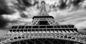 A striking black and white perspective of the Eiffel Tower under dramatic clouds in Paris. jigsaw puzzle