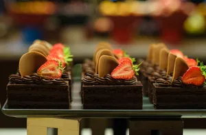 Mouth-watering chocolate cake slices adorned with fresh strawberries and chocolate rounds, perfect for dessert lovers. jigsaw puzzle