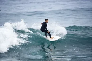 A skilled surfer balancing on the waves of the open ocean, capturing the thrill of surfing. jigsaw puzzle