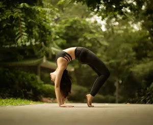 Woman performing yoga wheel pose in a peaceful outdoor park. Fitness and mindfulness in nature. jigsaw puzzle