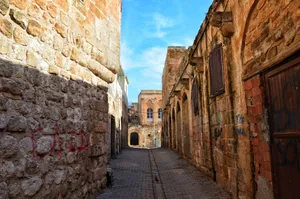 Explore the charm of an ancient narrow alley with rustic stone architecture and graffiti. jigsaw puzzle