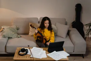 A girl with a violin taking an online music class in a cozy home setting. jigsaw puzzle