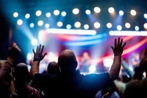 A vibrant scene of concert-goers enjoying a live music performance with colorful stage lights. jigsaw puzzle