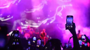 Vibrant concert with audience capturing moments on smartphones under dramatic lighting. jigsaw puzzle