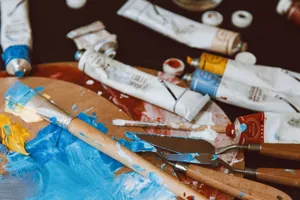 A close-up of a colorful artist's palette with paintbrushes and paint tubes, vibrant and inspiring. jigsaw puzzle