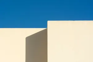 A minimalist architectural structure with white walls contrasting a vivid blue sky. jigsaw puzzle