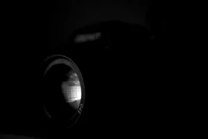 Dramatic black and white close-up of a camera lens with reflective highlights. jigsaw puzzle