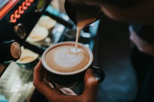 person pouring coffee on black ceramic mug jigsaw puzzle