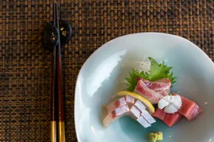 A white plate topped with sushi and chopsticks jigsaw puzzle