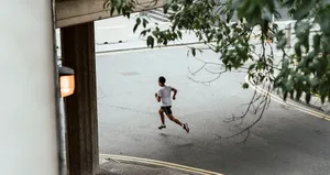 boy in white t-shirt and blue shorts running on gray concrete road during daytime jigsaw puzzle