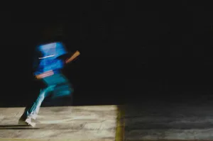 man in blue jacket and blue denim jeans walking on brown wooden plank during nighttime jigsaw puzzle