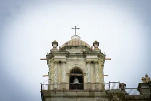 A clock tower with a cross on top of it jigsaw puzzle