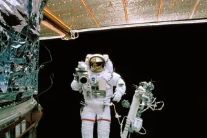 a man in a space suit standing next to a space station jigsaw puzzle