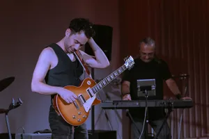 A man standing next to a keyboard and a guitar jigsaw puzzle