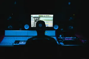 a man sitting in front of a computer in a dark room jigsaw puzzle