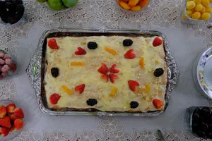 Delicious homemade fruit cake topped with fresh strawberries and blackberries, perfect for dessert. jigsaw puzzle