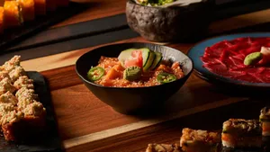 A vibrant assortment of Japanese sushi dishes including salmon poke bowl and assorted rolls. jigsaw puzzle