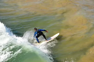 Surfer skillfully navigating ocean waves, showcasing balance and technique. jigsaw puzzle