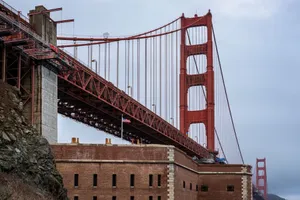 Close-up of the iconic Golden Gate Bridge with cloudy sky in San Francisco, showcasing architectural detail. jigsaw puzzle