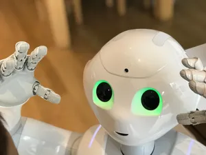 A futuristic humanoid robot with glowing green eyes in a modern setting. jigsaw puzzle