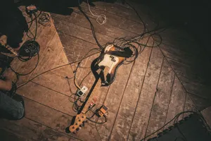 Electric guitar with pedals and cables on a rustic wooden stage floor, high angle. jigsaw puzzle