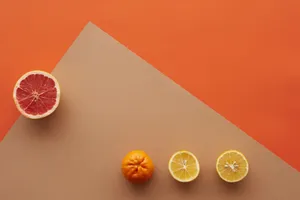 Minimalist top view of citrus fruits on an orange and beige background, perfect for fresh themes. jigsaw puzzle