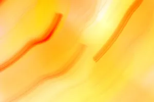Dynamic abstract image featuring vivid orange and yellow swirls with a warm, energetic mood. jigsaw puzzle