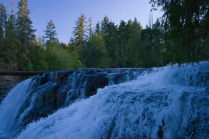 a waterfall in the middle of a forest jigsaw puzzle