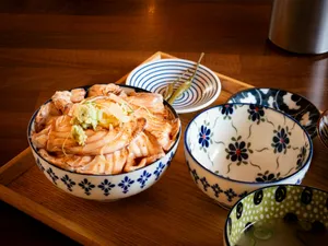 Salmon donburi with patterned bowls on a wooden tray. jigsaw puzzle