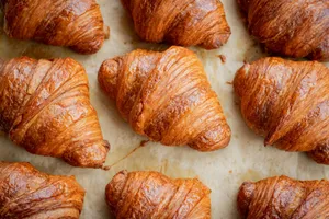 a bunch of croissants that are on a table jigsaw puzzle