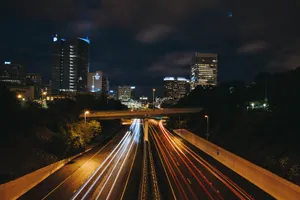 Dynamic night view of an urban highway with light trails and illuminated skyscrapers. jigsaw puzzle