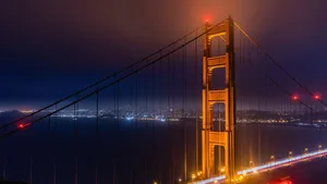 Stunning night view of the Golden Gate Bridge illuminated with city skyline in the background. jigsaw puzzle