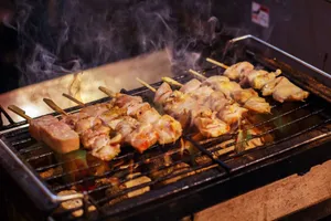 Delicious grilled chicken skewers sizzling with smoke and flame on a barbecue grill. jigsaw puzzle