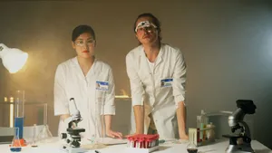 Two scientists conducting experiments in a lab, using microscopes and equipment. jigsaw puzzle