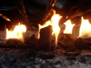 Intense close-up of roaring flames and glowing charcoal embers. jigsaw puzzle