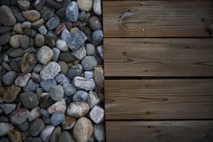 Aerial view of assorted stones next to wooden deck planks, showcasing textures. jigsaw puzzle
