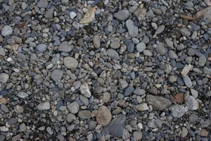 A detailed close-up view of assorted pebbles and stones in natural colors, showcasing textures. jigsaw puzzle