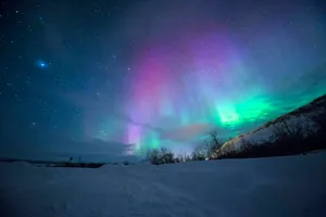 northern lights over snow-capped mountian jigsaw puzzle