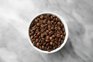A small white bowl filled with coffee beans jigsaw puzzle