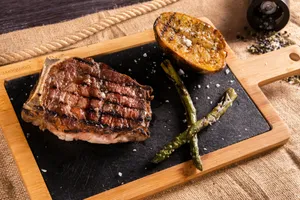 a steak and asparagus on a cutting board jigsaw puzzle