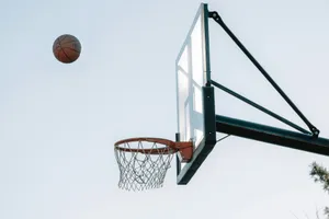 a basketball flying through the air next to a basketball hoop jigsaw puzzle