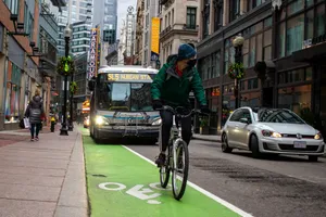man in black jacket riding bicycle on road during daytime jigsaw puzzle