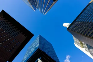 a group of tall buildings with a blue sky in the background jigsaw puzzle