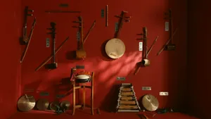 Collection of traditional string and percussion instruments on red wall jigsaw puzzle