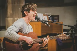 man in gray v neck long sleeve shirt playing brown acoustic guitar jigsaw puzzle